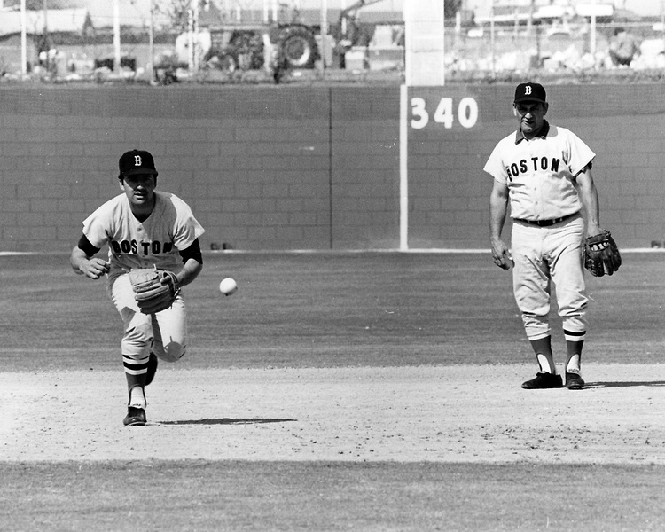 Rico Petrocelli takes infield practice at third base during spring training as Frank Malzone looks on. (Photo by Boston Red Sox)
